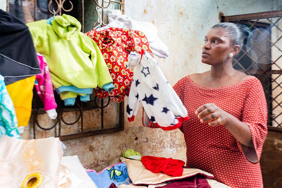 Cameroon woman displays handmade clothing