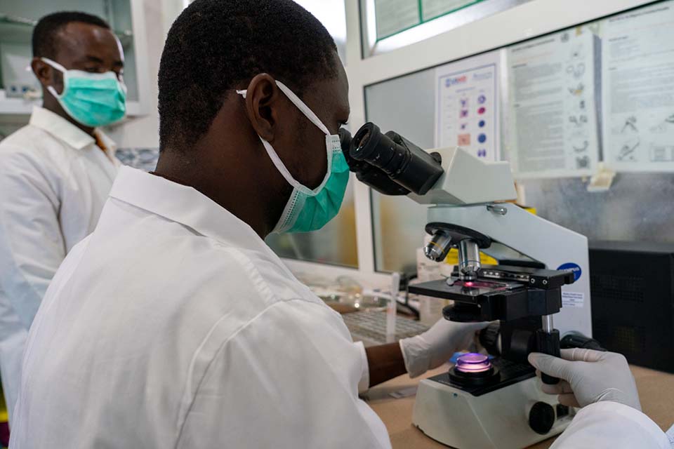 lab tech at microscope in Liberia