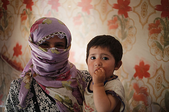 Zahaya and her son fled their home in Syria to escape the escalating violence and are now living in a tent in Lebanon and relying on support from CRS and our partners. Photo by Sam Tarling for CRS