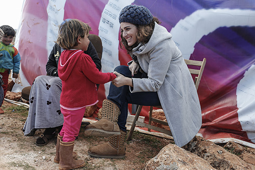 CRS Lebanon project manager Soha Menassa talks with a Syrian refugee from Raqqa in a tent-settlement in in Lebanon's Bekaa Valley. Photo by Sam Tarling for CRS