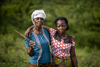 Photo by Michael Stulman/CRS Nora Tolee and Martha Yelekor farm cassava with their neighbors in Nimba County, Liberia.