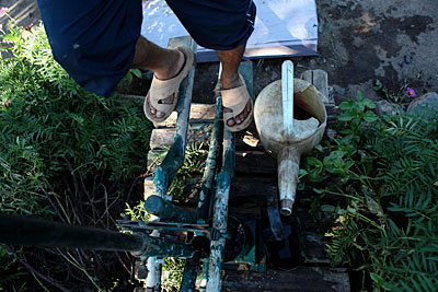 Jean Marie Rasamimanana works a treadle pump to irrigate his family's farm in Madagascar. Photo by Sara A. Fajardo/CRS