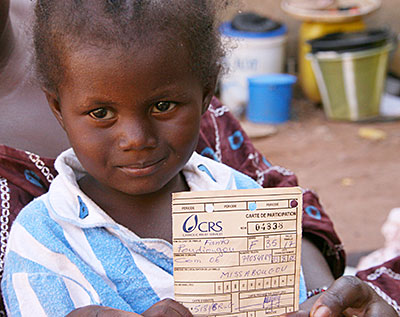 Three-year-old Saouda Keita lives with 16 family members in rented rooms near Mali's capital, Bamako. CRS provides monthly cash distributions to families that fled rebel control to the north. Photo by Helen Blakesley/CRS