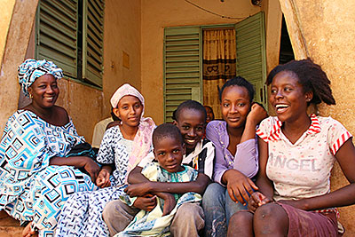 Hawa Tour, far left, is one of 200,000 Malians displaced by violence in northern Mali. She and her family have taken refuge at a relative's home in the nation's capital to the south. Photo by Helen Blakesley/CRS