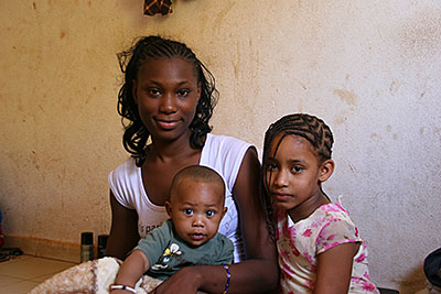 Djélika Haïdara fled her home in Timbuktu, Mali, while still pregnant with 5-month-old Ousmane, center. They now live in the capital, Bamako, where CRS is helping them with their rent. Photo by Helen Blakesley/CRS
