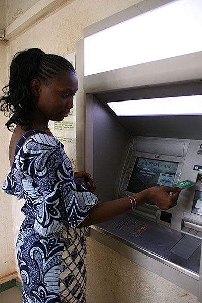 CRS is providing Djélika with a debit card that allows her to withdraw funds as she needs them. Photo by Helen Blakesley/CRS