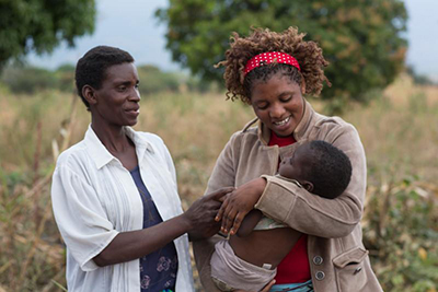 THRIVE project officer Lucia Maele helped Teresa Kananji, left, get Promisi physical therapy and a therapeutic chair. Photo by Sara A. Fajardo/CRS