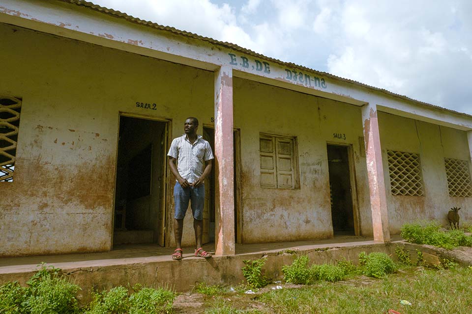man standing outside school in Guinea Bissau