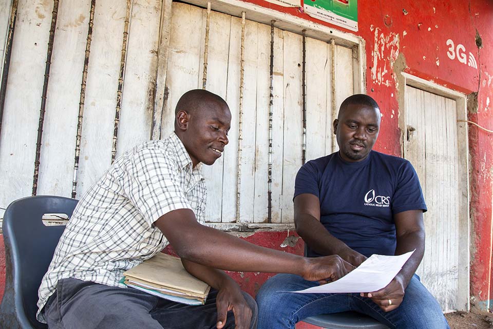 CRS MIRA enumerator discusses data with CRS staff