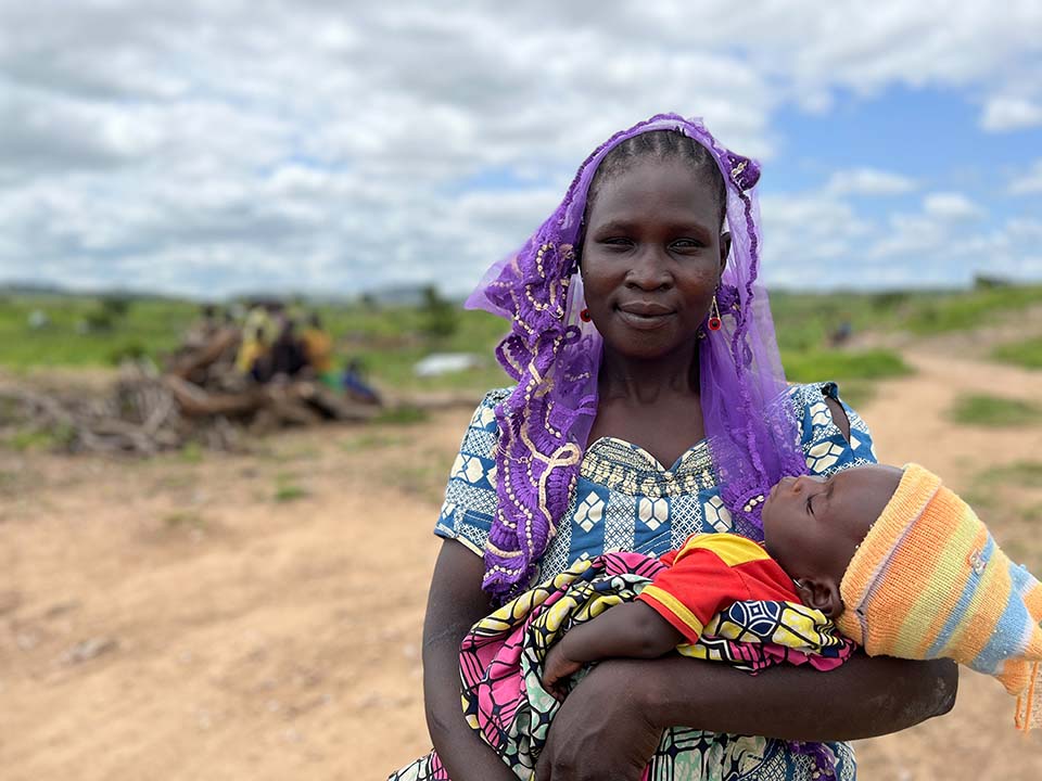 mother facing camera and holding child in Cameroon