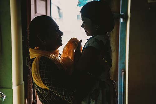 mother holding child in India