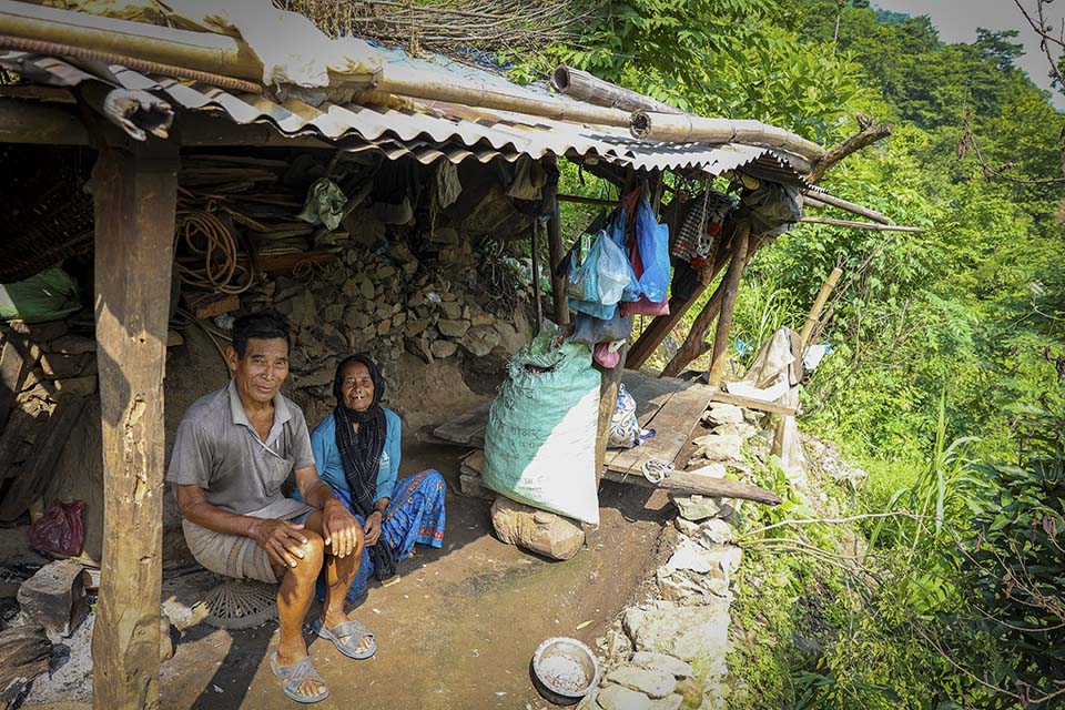 Nepal family sits together in temporary shelter