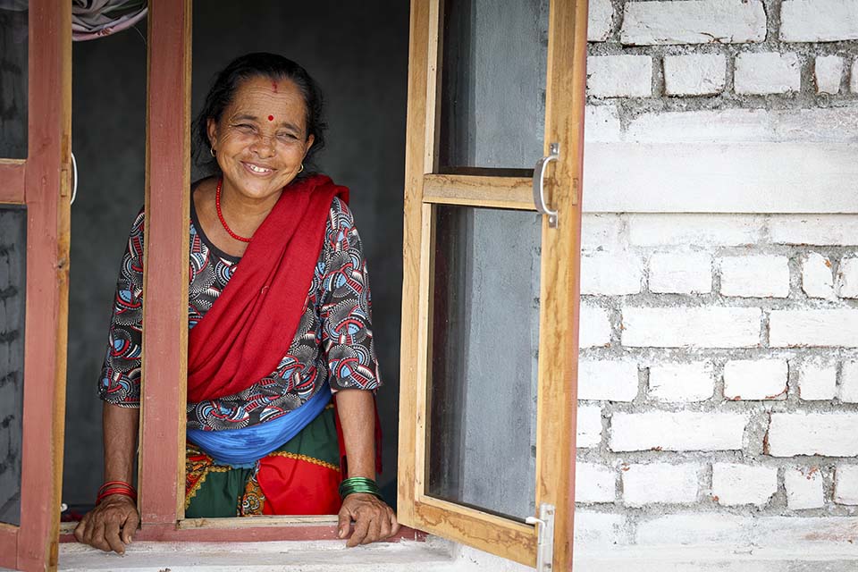 nepal_woman_looks_out_window_of_her_homen