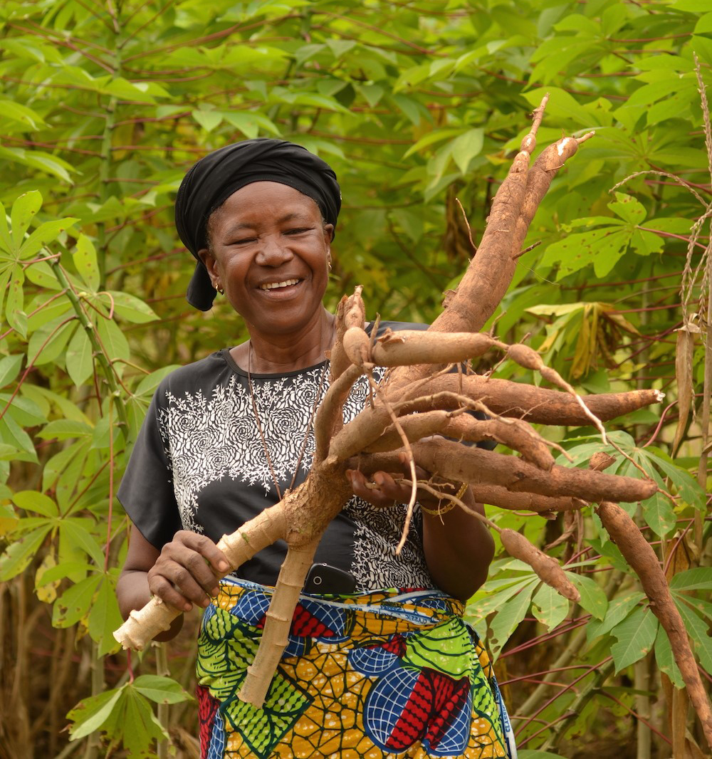 CRS helps Mwuese Jato produce and sell a new variety of cassava plants. She also participates in financial management training. With the income she earned from her last harvest, Mwuese supports her family. Photo by Michael Stulman/CRS