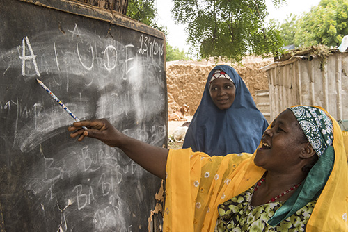 A literacy class in Ruwawuri, Nigeria helps women learn the skills needed to earn a living with dignity. Photo by Michael Stulman/CRS