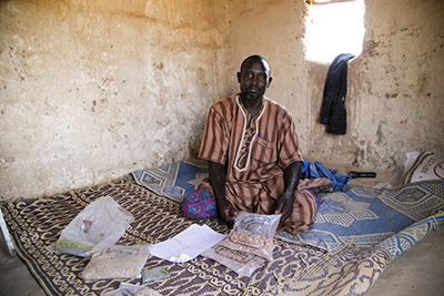 Chaibou Alzouma, with seeds he is selling through a CRS project in Niger.  They grow faster and are more resistant to drought. Photo by Michael Stulman/CRS