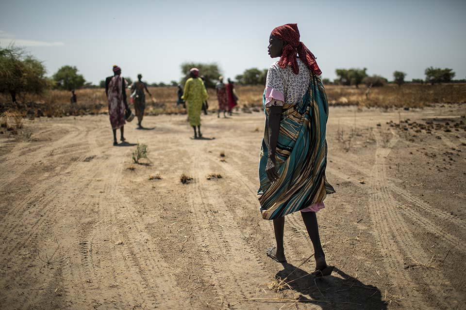 women walk parched landscape in South Sudan
