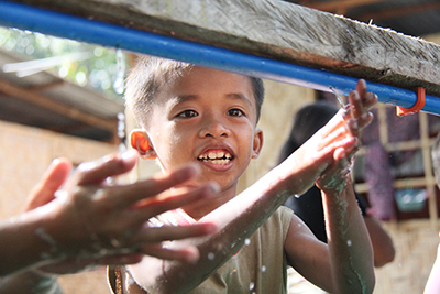 Hand-washing stations protect children from diseases like diarrhea, cholera and typhoid. Photo by Jennifer Hardy/CRS