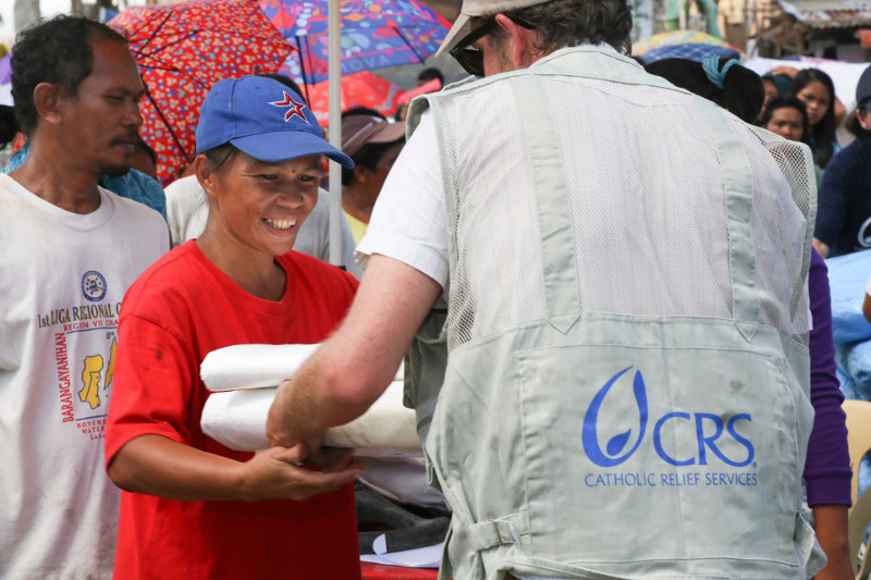 CRS distributes plastic tarps for emergency shelter in the town of Palo after a deadly typhoon in the Philippines.