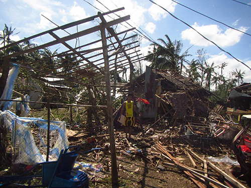 On the island of Samar, where Typhoon Hagupit made landfall on December 6, 2014, many houses made from light materials like nipa and bamboo suffered extensive damage, collapsed or had their roofs blown off. Photo by CRS staff.