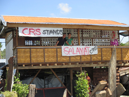 Esperanca and Benedicto Militante, Sr., residents of Palo, Leyte, are grateful their house withstood Typhoon Hagupit. CRS helped them build a storm-resistant home after last year's devastating Typhoon Haiyan. Photo by Charlie David Martinez for CRS