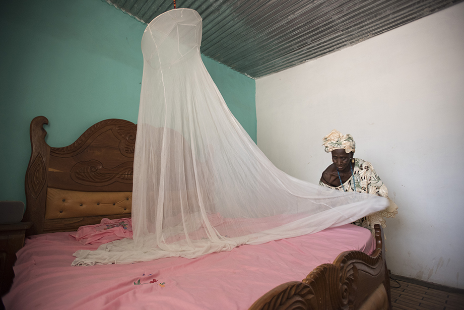 preparing a malaria net in the gambia