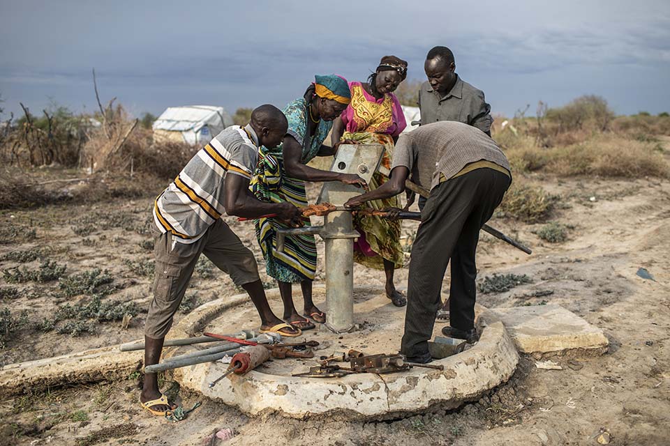 pump mechanics dismantle a well pump in South Sudan