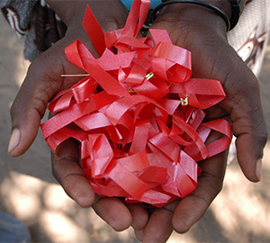 hands holding red ribbons