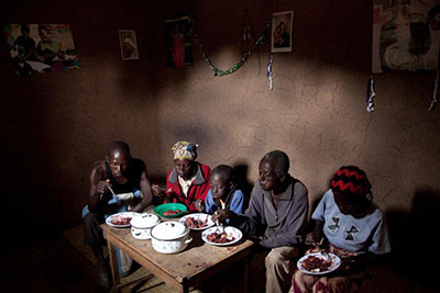 A family in Gisheke village, Rwanda, eats a nutritious lunch thanks to the vegetable garden they've learned to grow in a CRS project to help coffee farmers. Photo by Laura Elizabeth Pohl for CRS.