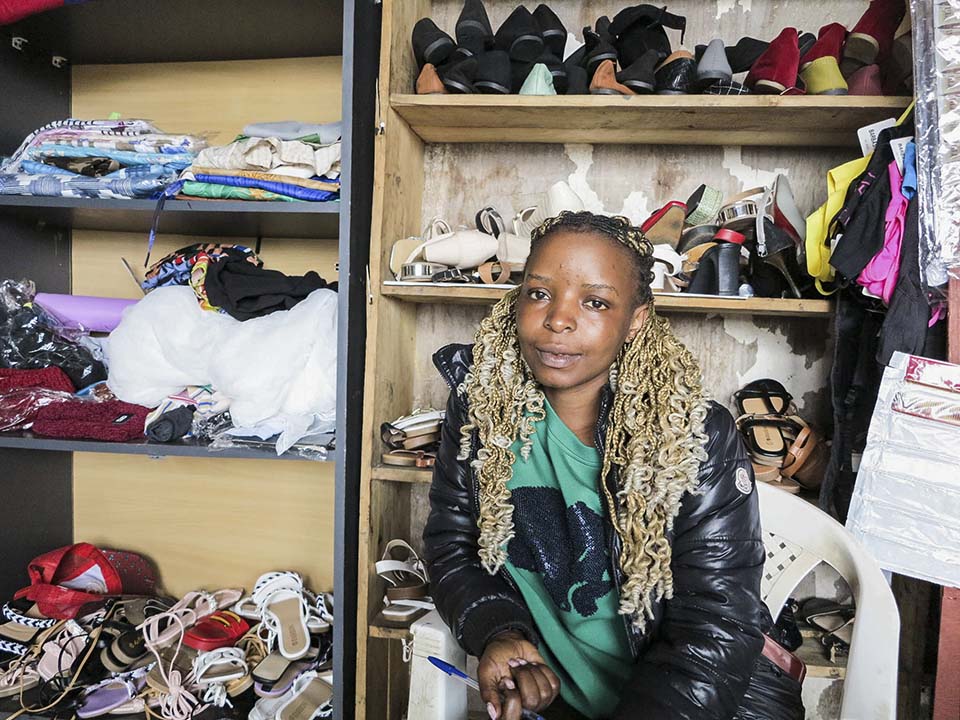 Rwanda shopkeeper displays her products