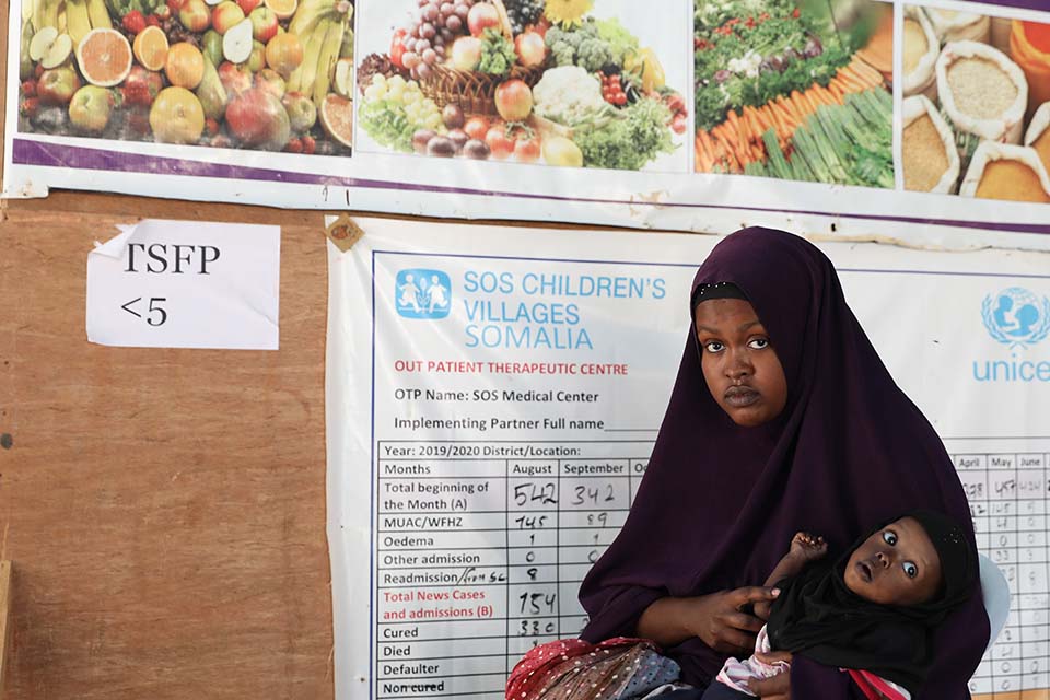 Somali woman with child waiting for health care 