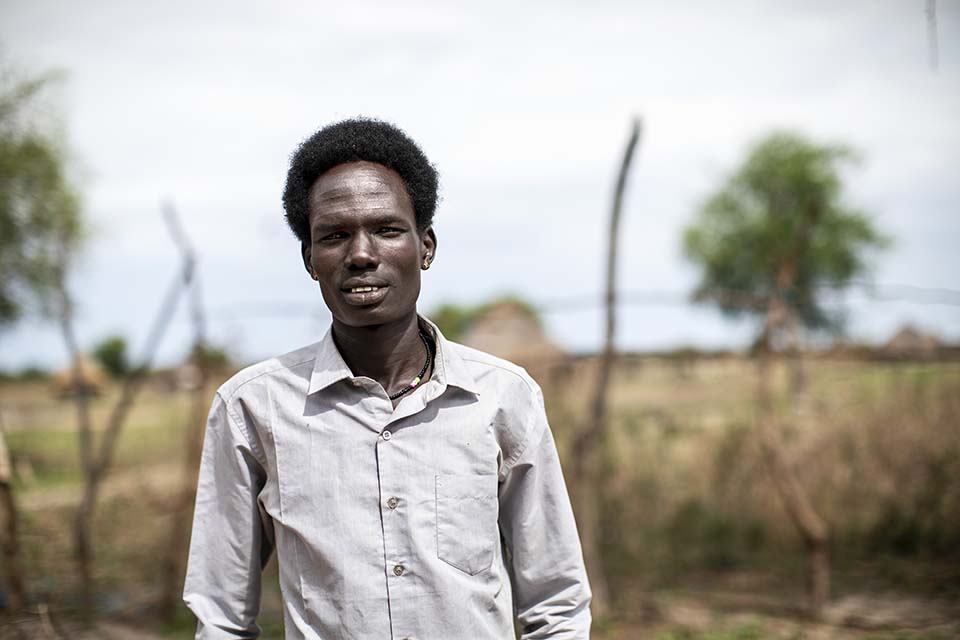 South Sudanese man standing outside