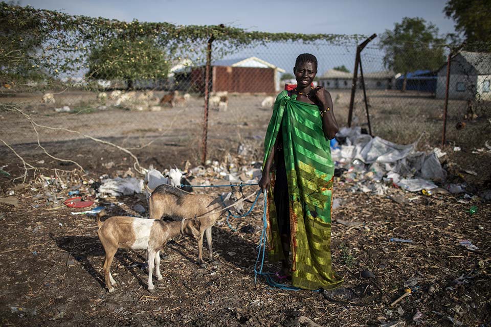 South Sudanese woman tending her goats