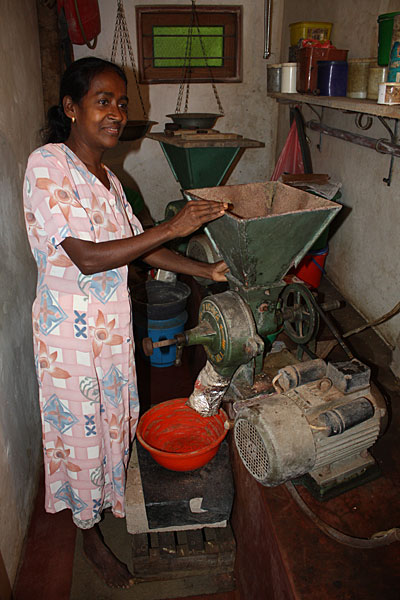 Chandra, 52, grinds tea leaves as part of her home-based business in Sri Lanka. Caritas Kandy gave her a loan to build a shop where she can sell tea and the produce she grows. Photo by Laura Sheahen/CRS