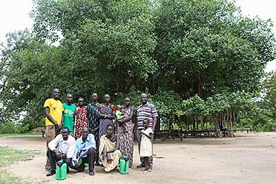 Members of the Tuktiop Farmers' Group stand in front their inspiration: a ficus tree planted by a missionary in 1905. Photo by Sara A. Fajardo/CRS