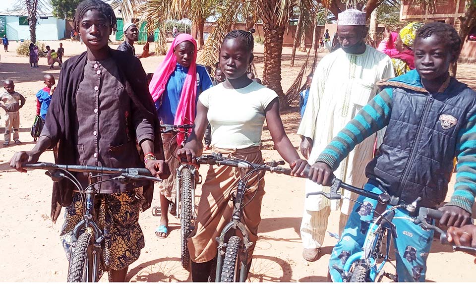 students on bikes in Mali