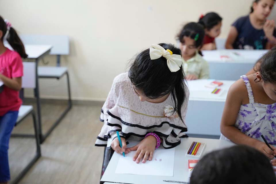 Syrian girl at desk in school in Jordan