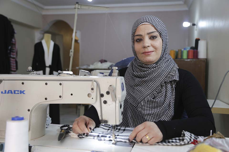 Syrian refugee business woman with her sewing machine