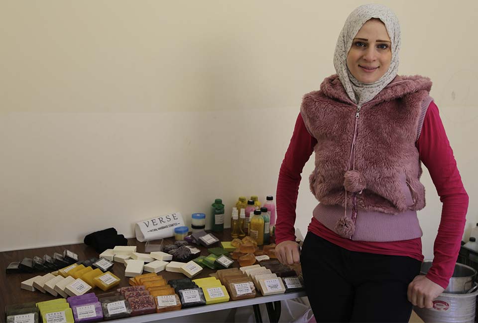 Syrian refugee business woman displays samples of her products