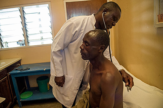 Dr. Simon Megiroo listens to Stephen Kipuyo's lungs during a check-up at Selian Hospital in Tanzania. Photo by Karen Kasmauski for CRS