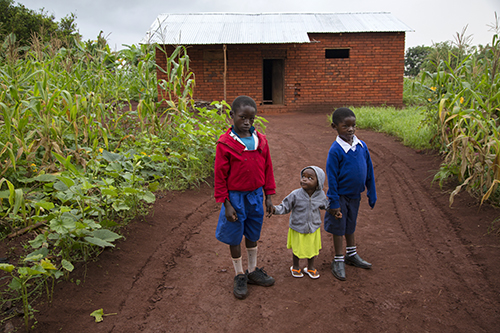 Profits from soybeans meant Gertruda could build a new home and buy school uniforms for grandsons Erik, left, and Greymanus, right, with their younger cousin, Gertruda. Photo by Sara A. Fajardo/CRS