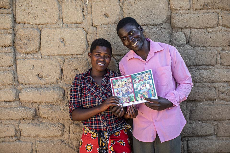 wife and husband face camera smiling in Tanzania