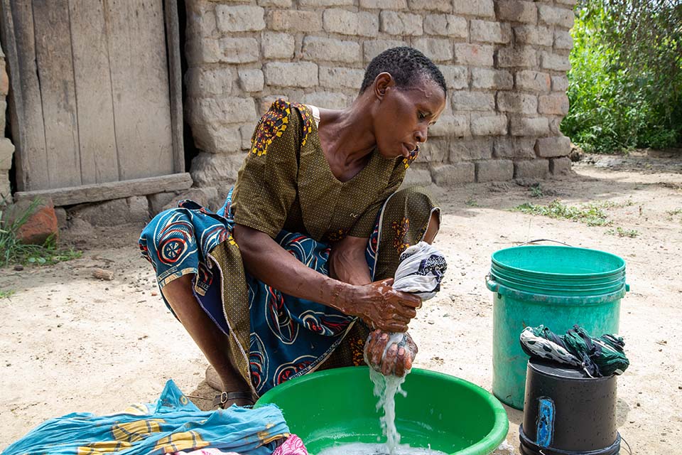 woman washes clothes in Tanzania