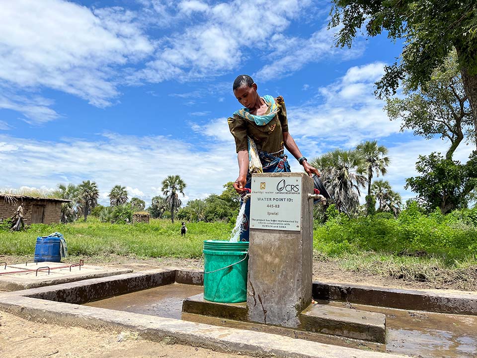 woman at water station in Tanzania