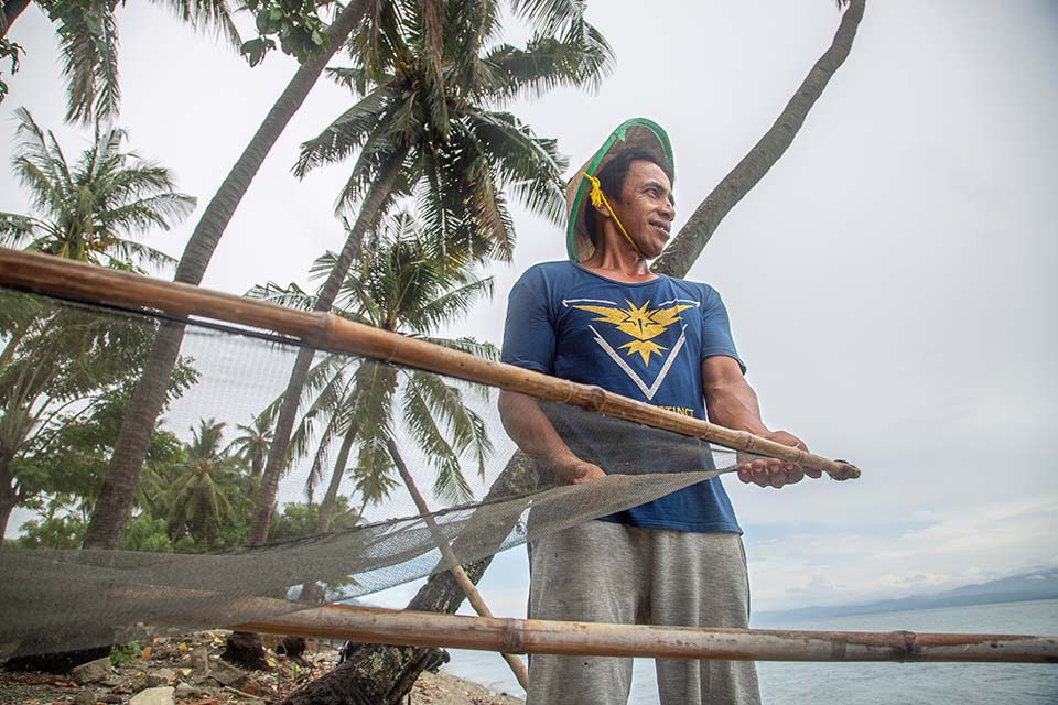 tsunami survivor with fishing net