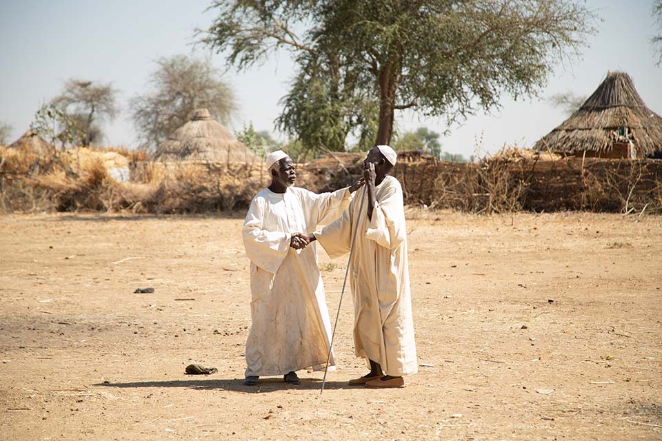 Two men greeting each other in Hashaba, West Darfur