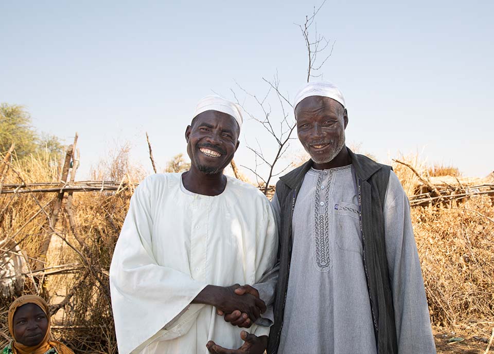 Two men greeting each other in Hashaba, West Darfur