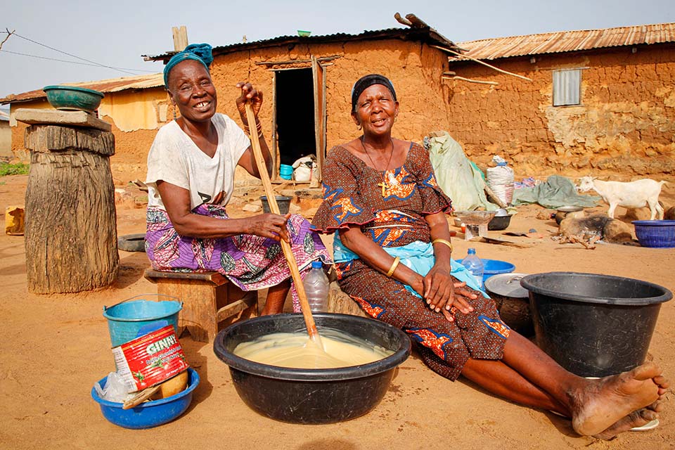 two women in Benin making shea butter