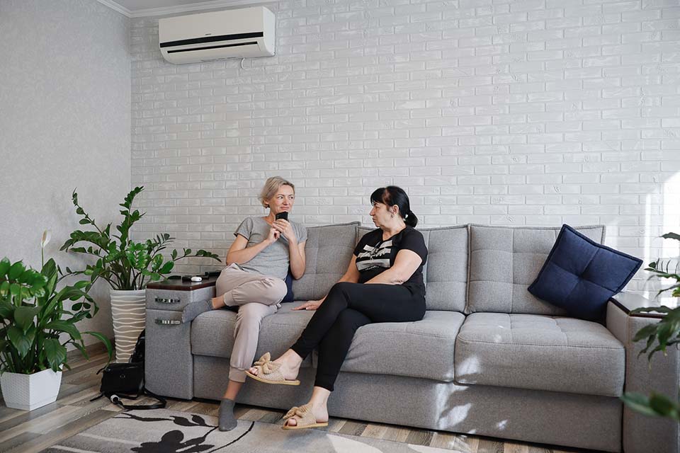 two women talking on couch in Moldova