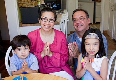 From left, Lucas, Sonia, Chris and Marina Arriola of California use Operation Rice Bowl to help them observe Lent from a global perspective. Photo by Philip Laubner/CRS